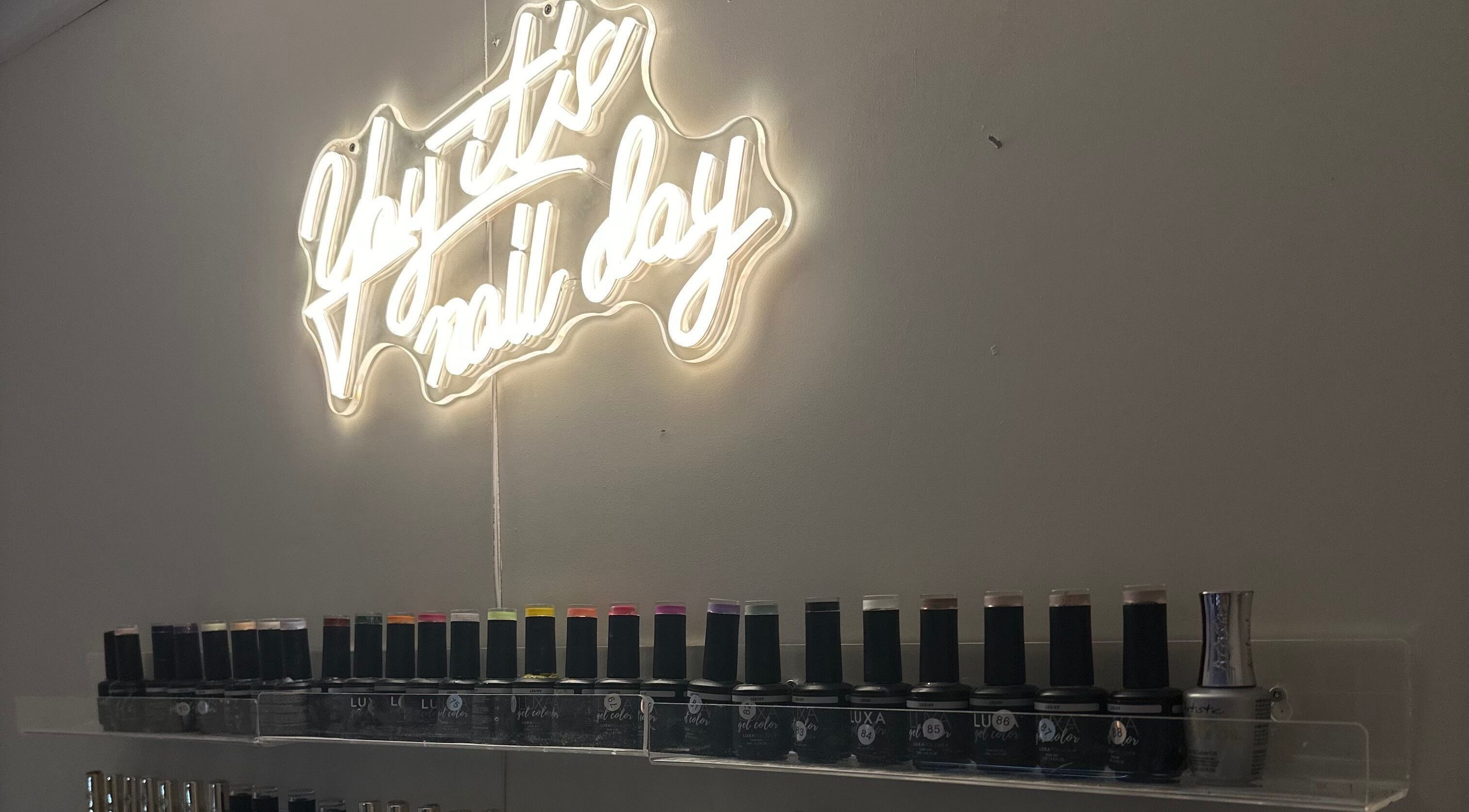 Neon sign 'yay it's nail day' and nail polish display at Milkshake Nails & Tan, Waitara, Taranaki, NZ.