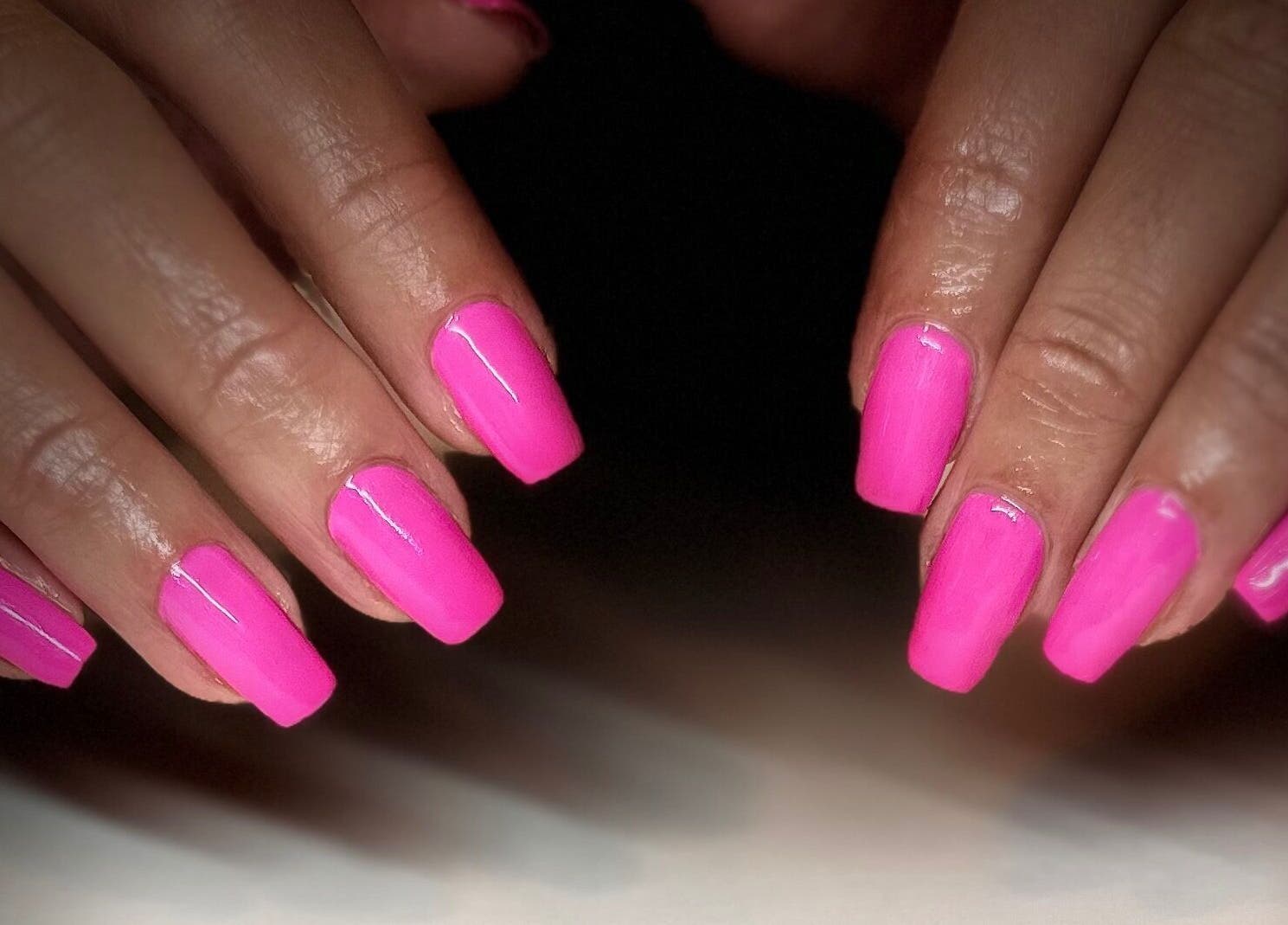 Bright pink manicured nails at Milkshake Nails & Tan, Waitara, Taranaki, NZ, showcasing expert nail artistry.