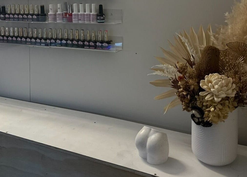 Sleek nail polish display and florals at Milkshake Nails & Tan, Waitara, Taranaki, NZ.