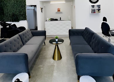 Elegant waiting lounge in HR Hair Studio, Auckland, Auckland, NZ with modern sofas and decor.