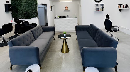 Elegant waiting lounge in HR Hair Studio, Auckland, Auckland, NZ with modern sofas and decor.