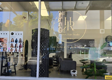 Exterior view of HR Hair Studio in Auckland, NZ, showcasing modern salon interior with stylish décor.