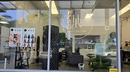 Exterior view of HR Hair Studio in Auckland, NZ, showcasing modern salon interior with stylish décor.