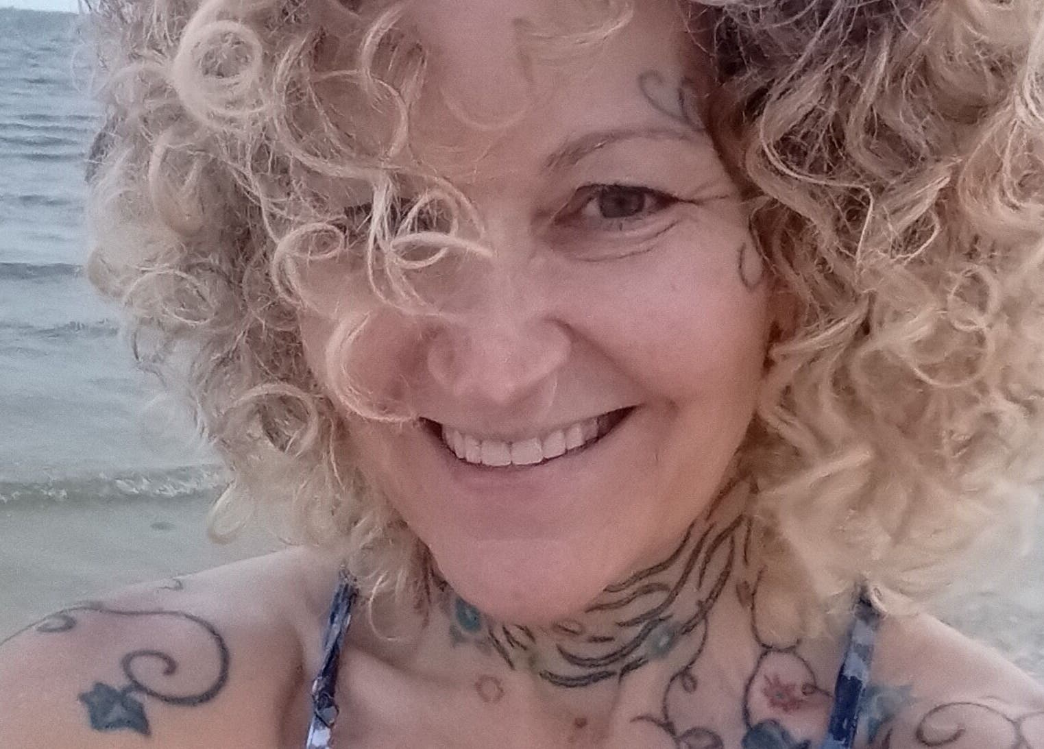 Smiling individual by the ocean, Ocean Springs. Kathryn Lane, NASM CPT, CNC, MWC venue.