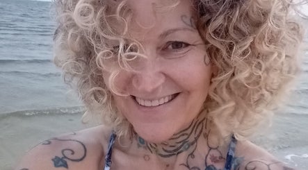 Smiling individual by the ocean, Ocean Springs. Kathryn Lane, NASM CPT, CNC, MWC venue.