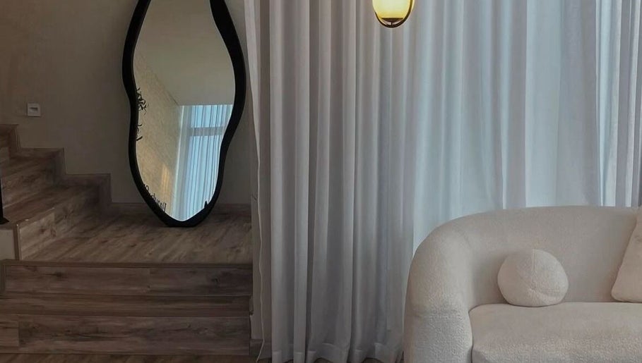 Chic interior at Beauty In My Hair, Riyadh, Riyadh Province, SA featuring a unique mirror and plush seating.
