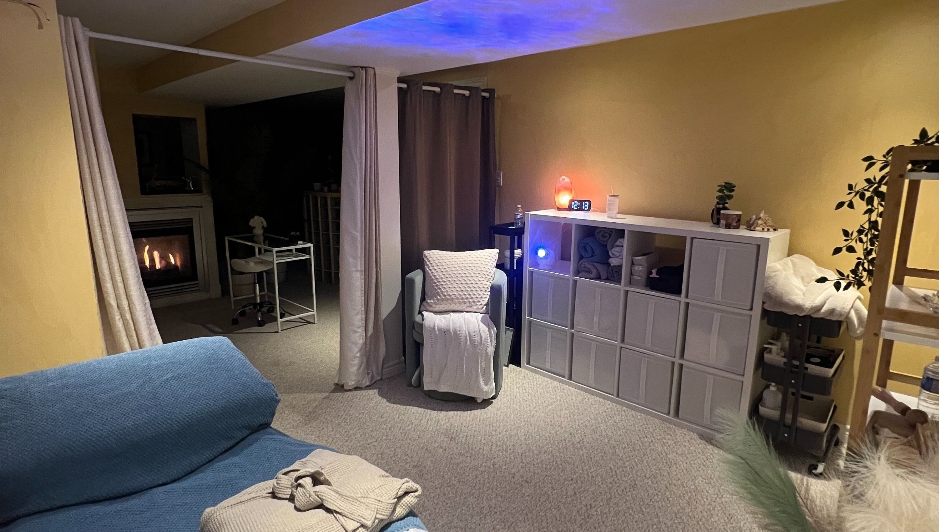 Warm treatment room at Diamond Kollective Aesthetics, Vaughan, Ontario, CA with elegant decor and fireplace.