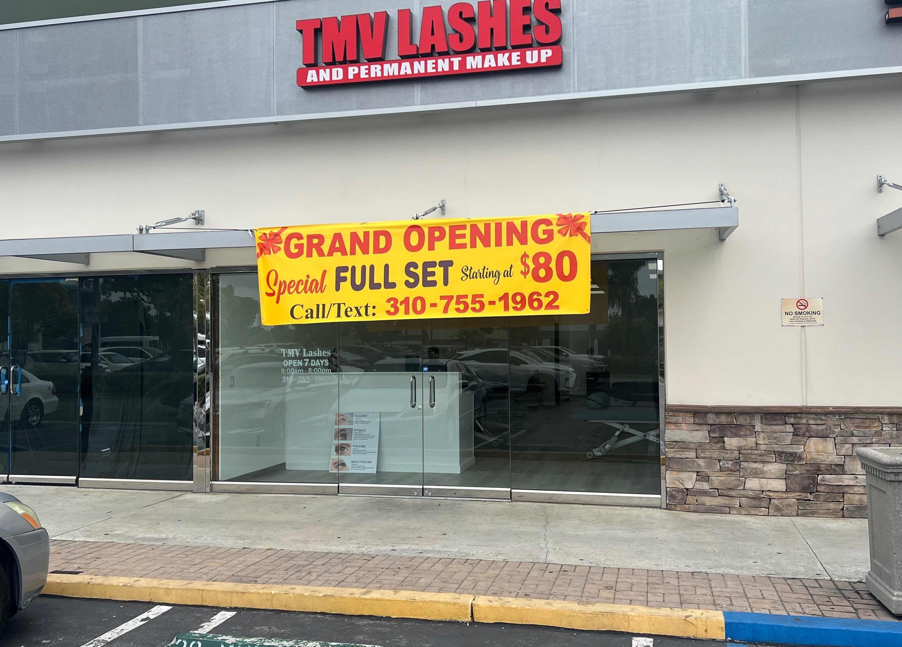 Tmv Lashes storefront in Carson, California, US, with grand opening banner for lash services.