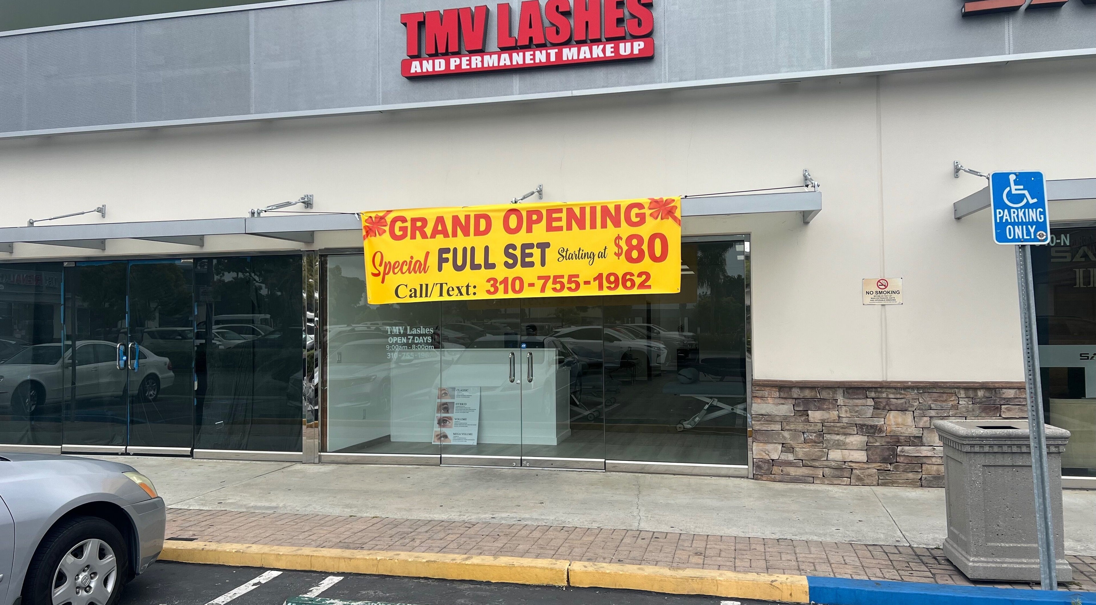 Tmv Lashes storefront in Carson, California, US, with grand opening banner for lash services.