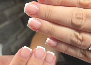 Close-up of elegant French manicure at Nails By Kaili-Jade, Nuneaton, England, GB showcasing glossy finish and precision.