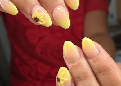 Sunflower nail art design at Nails By Kaili-Jade in Nuneaton, England, GB, showcasing vibrant yellow gradients.