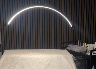 Treatment room with ambient lighting at Koi Beauty London, London, England, GB showcasing cozy wellness space.