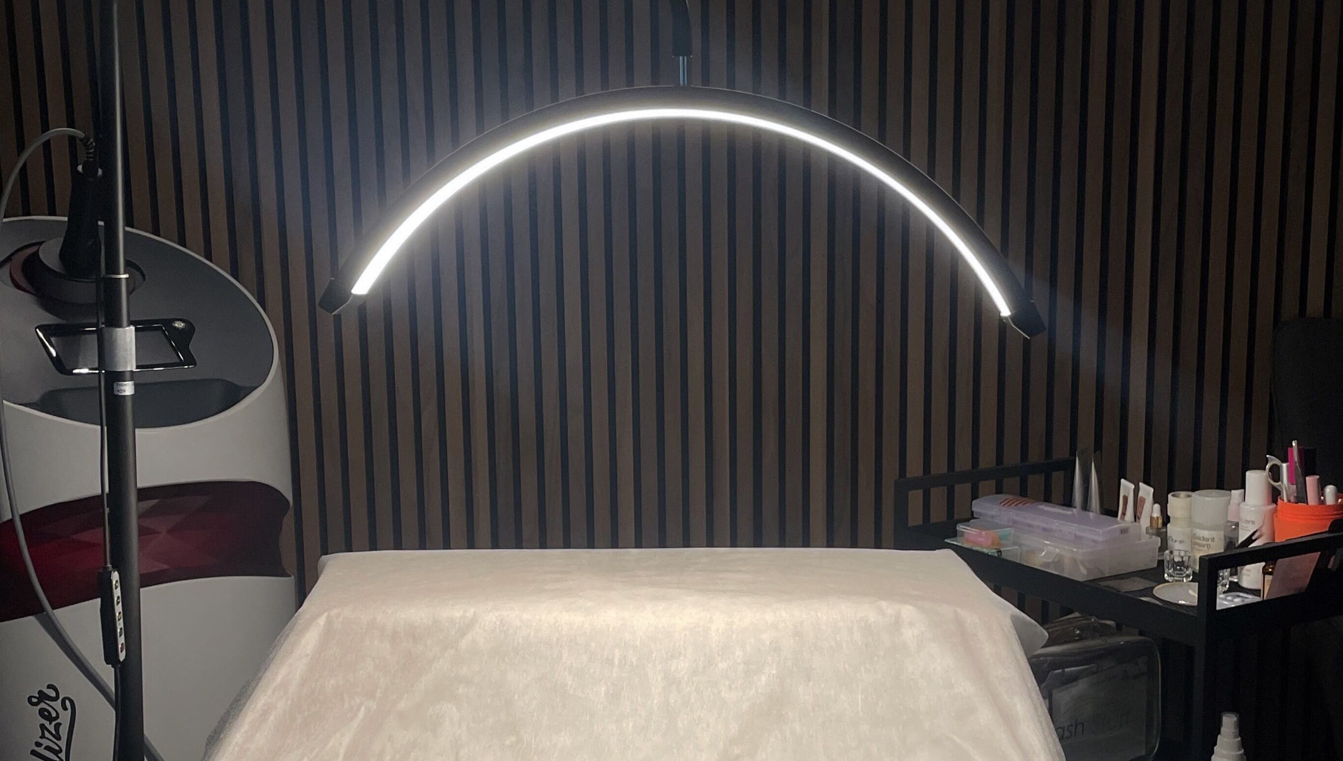 Professional treatment setup at Koi Beauty London, London, England, GB. Modern lighting and tools visible.