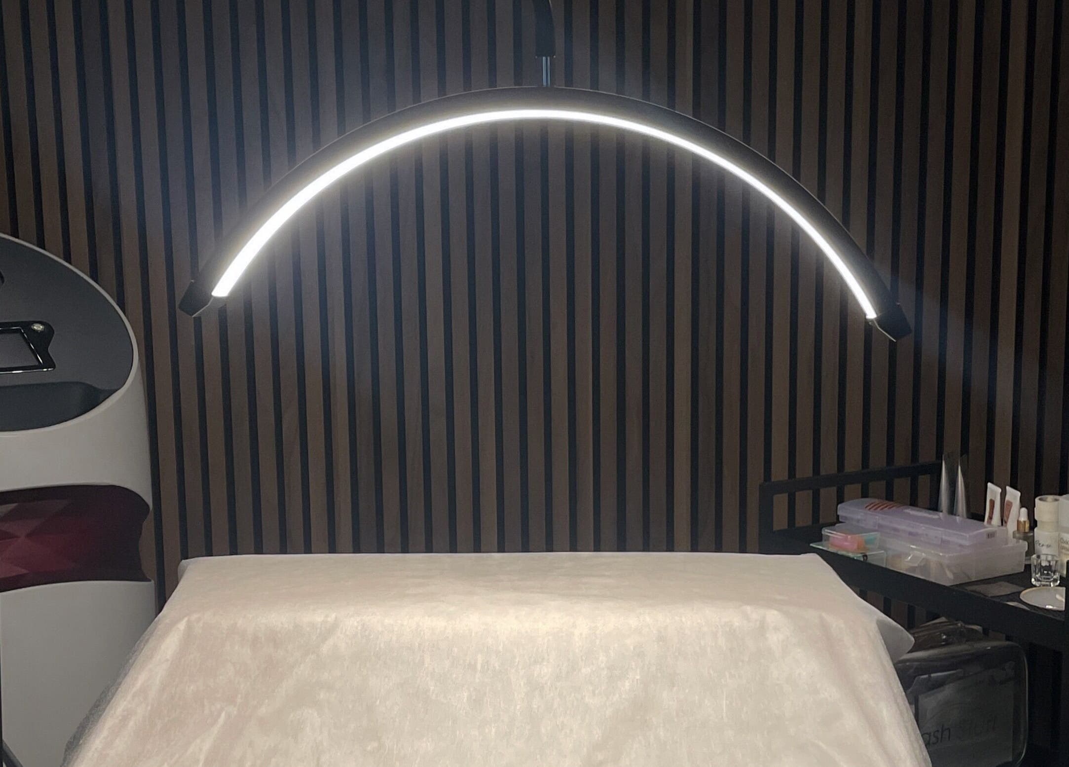 Professional treatment setup at Koi Beauty London, London, England, GB. Modern lighting and tools visible.