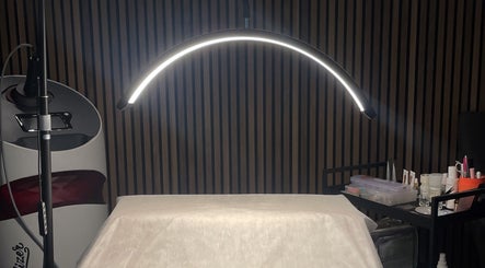 Professional treatment setup at Koi Beauty London, London, England, GB. Modern lighting and tools visible.