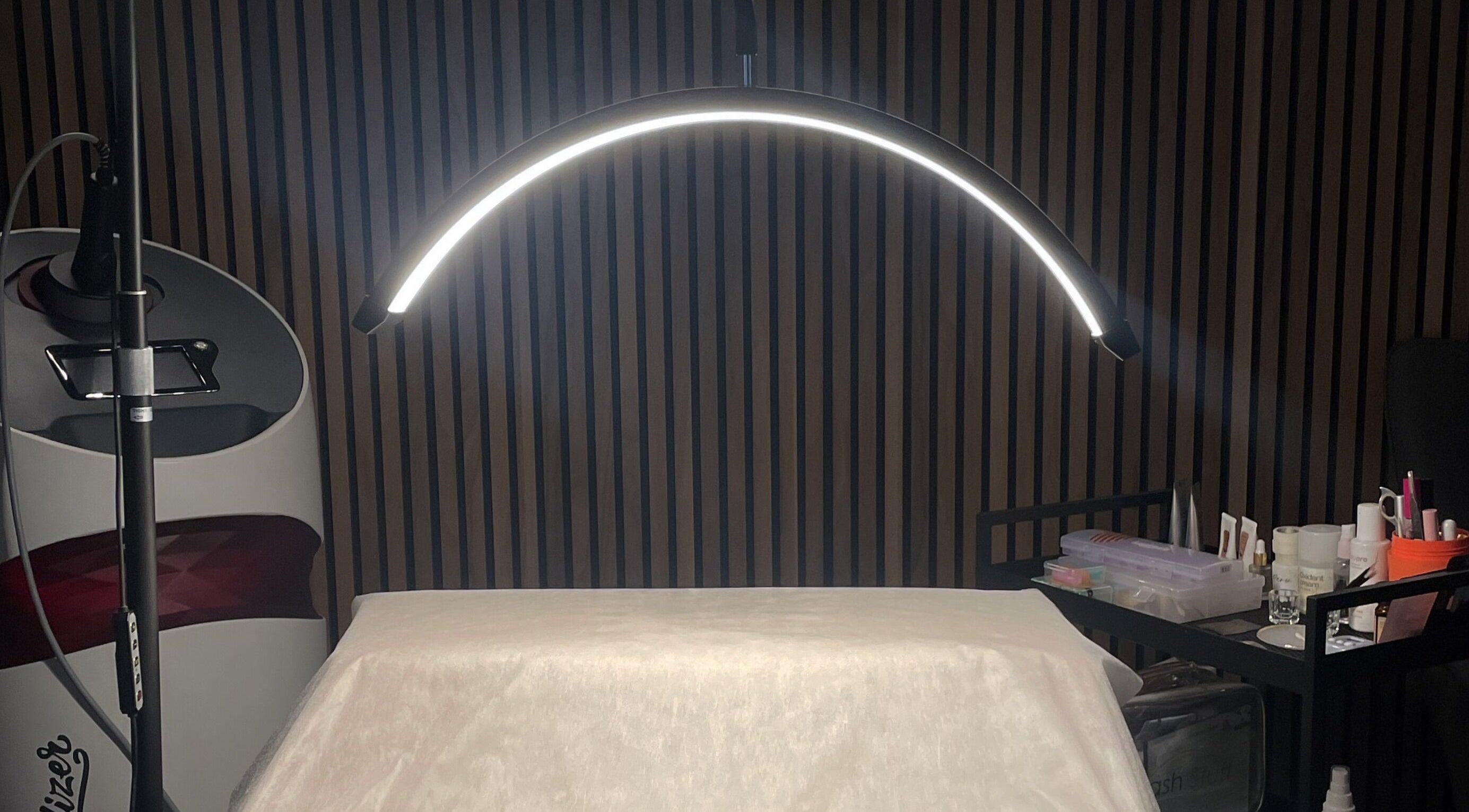 Professional treatment setup at Koi Beauty London, London, England, GB. Modern lighting and tools visible.