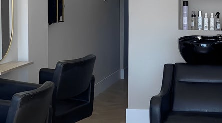 Elegant interior of Nevada Hair Studio in Edinburgh, Scotland, showcasing modern salon chairs and sleek hair products.
