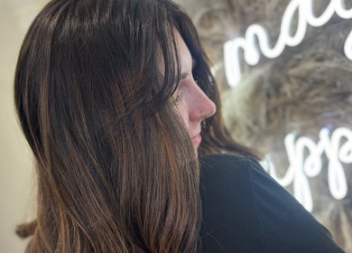 Elegant hairstyle at Nevada Hair Studio, Edinburgh, Scotland, GB with neon lights in the background.