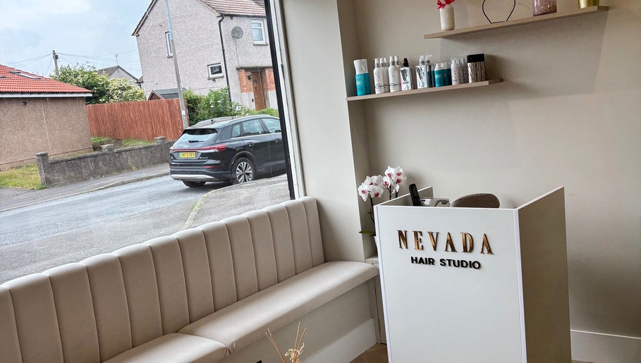 Entrance view of Nevada Hair Studio in Edinburgh, Scotland, GB with elegant sofa and reception desk.