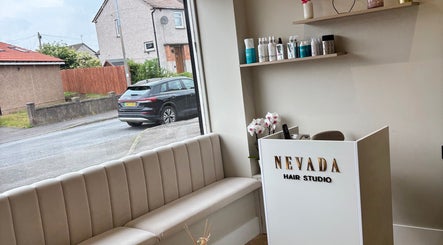 Entrance view of Nevada Hair Studio in Edinburgh, Scotland, GB with elegant sofa and reception desk.