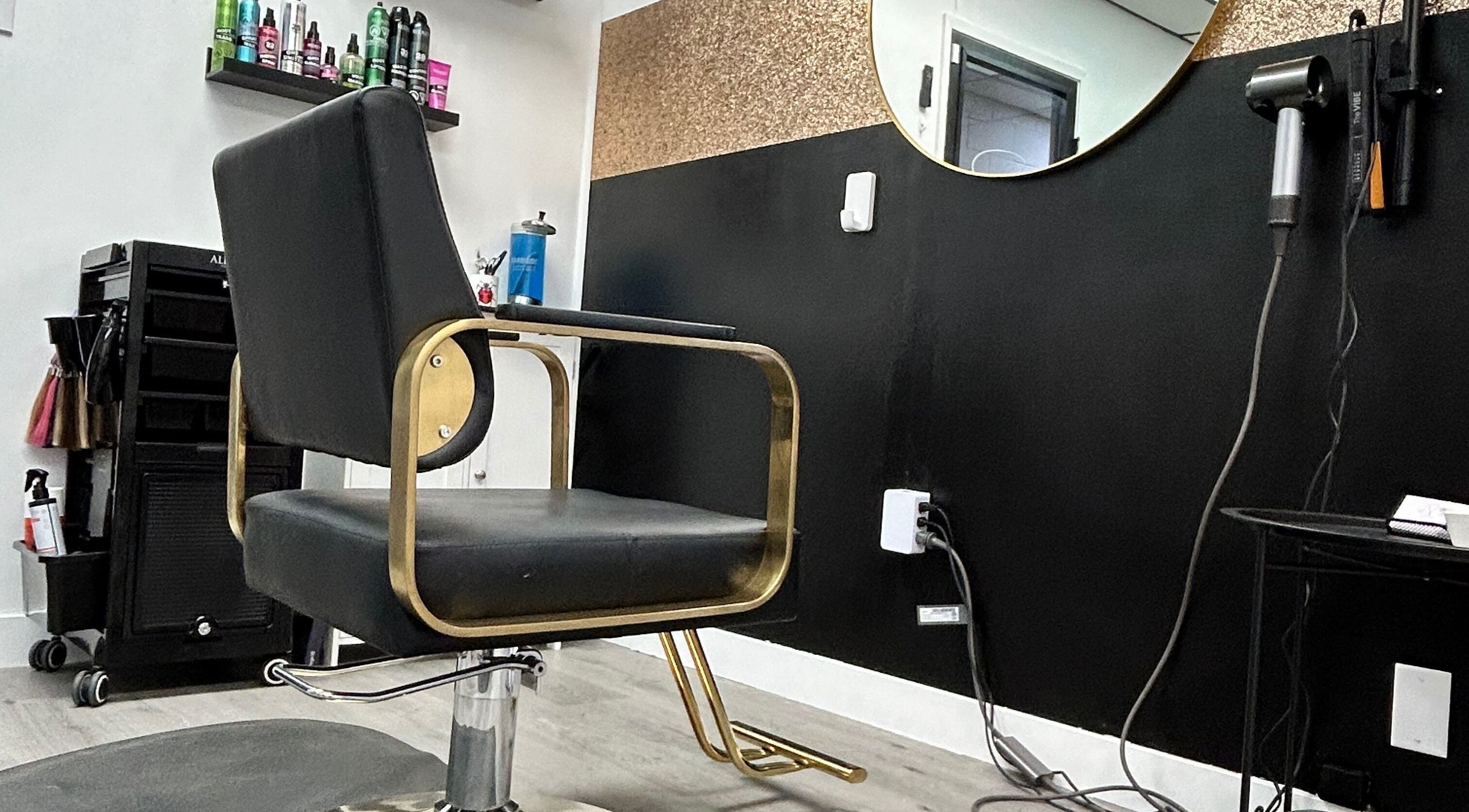 Elegant styling chair and mirror at Salon 99 in Stettler, Alberta, CA, highlighting modern salon interiors.
