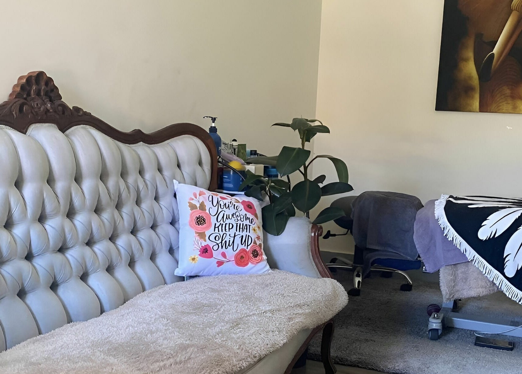 Elegant massage room at Essentially U Massage, New South Wales, AU, featuring plush sofa and treatment bed.