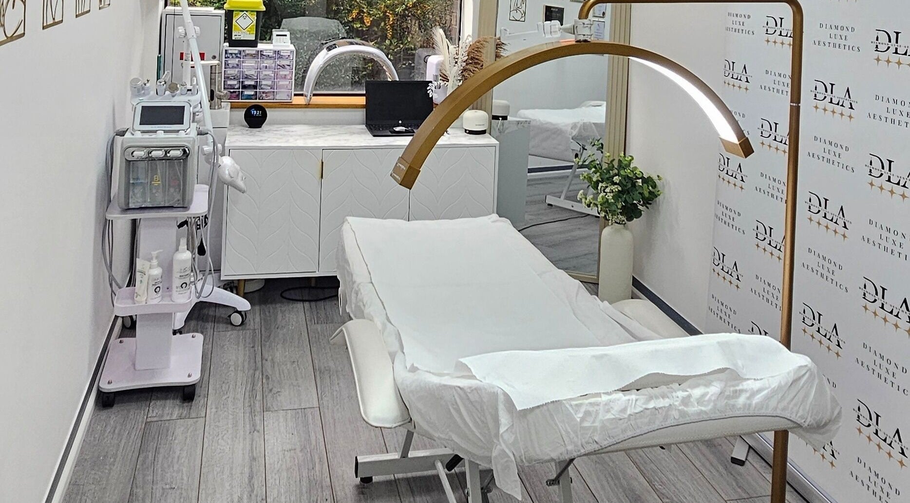 Elegant treatment room at Diamond Luxe Aesthetics, Uxbridge, England, GB, featuring modern equipment.