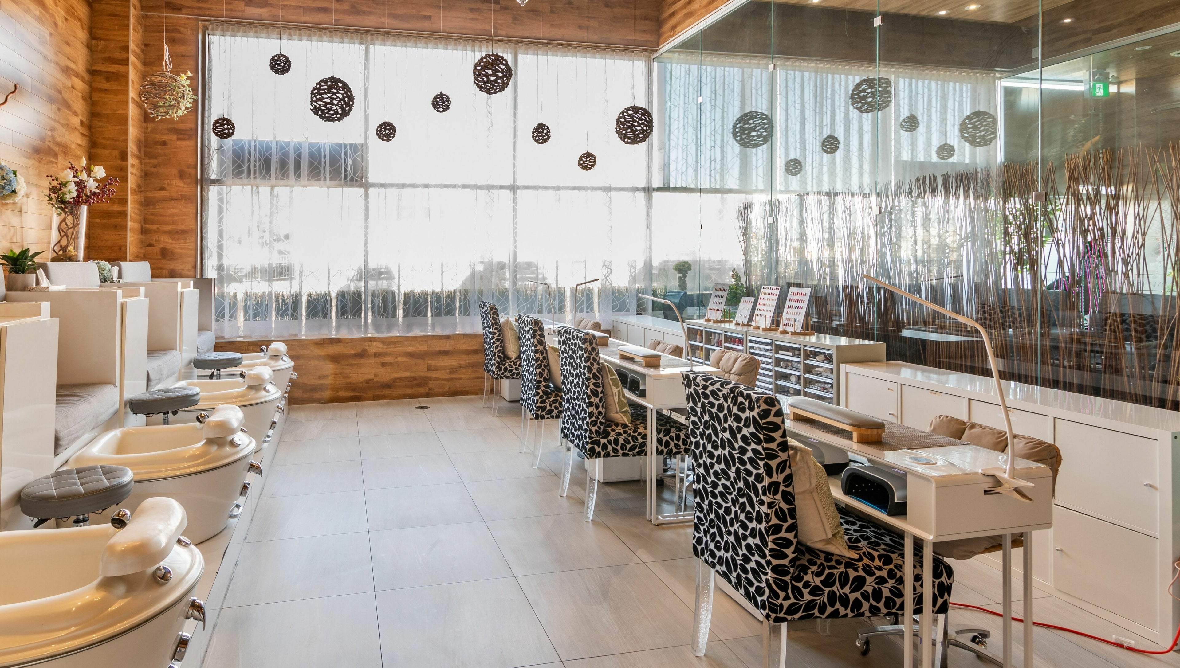 Elegant nail salon seating area at Aroma Day Spa in Markham, Ontario, CA, showcasing plush chairs and nail stations.