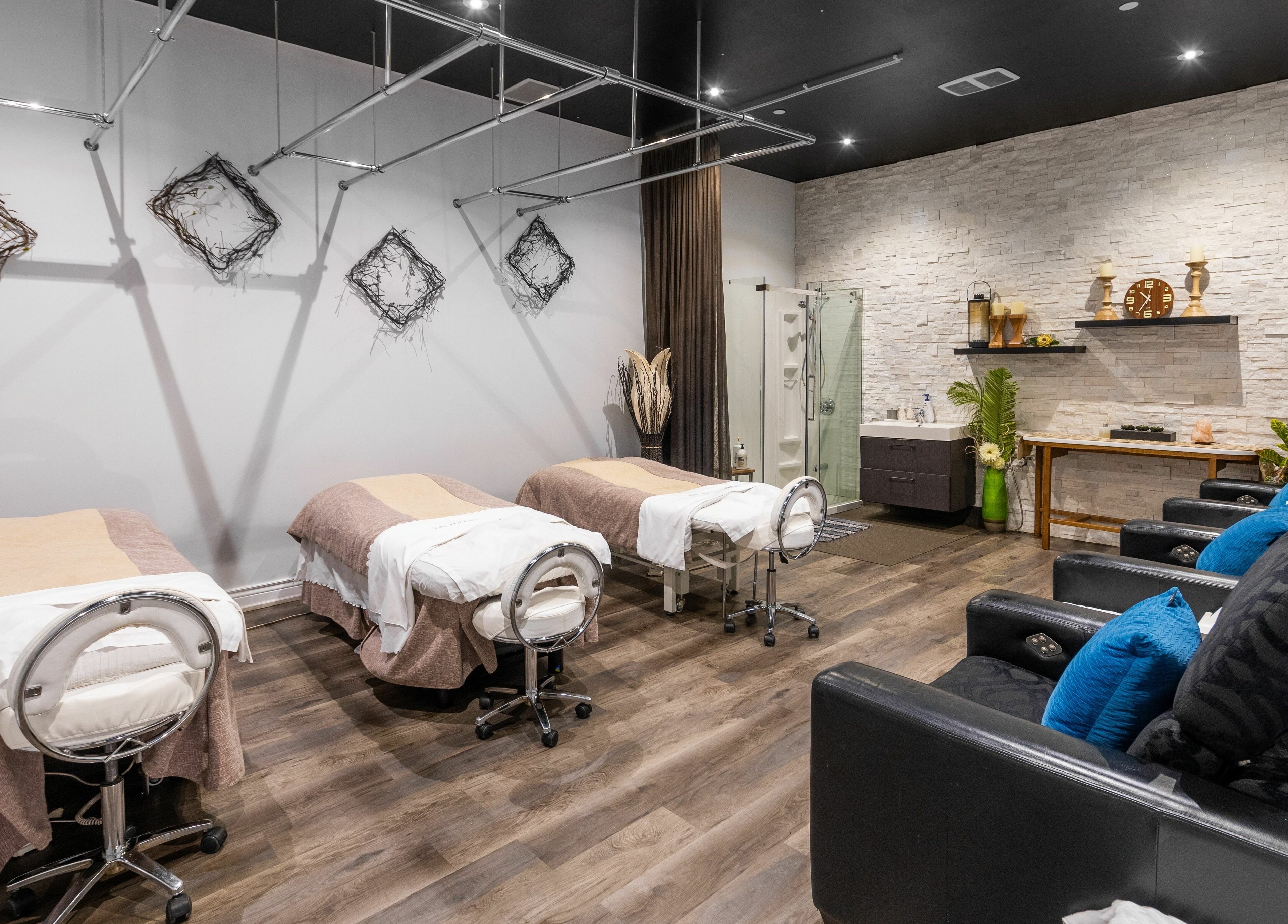 Relaxing massage room at Aroma Day Spa, Markham, Ontario, CA with three beds and cozy decor.