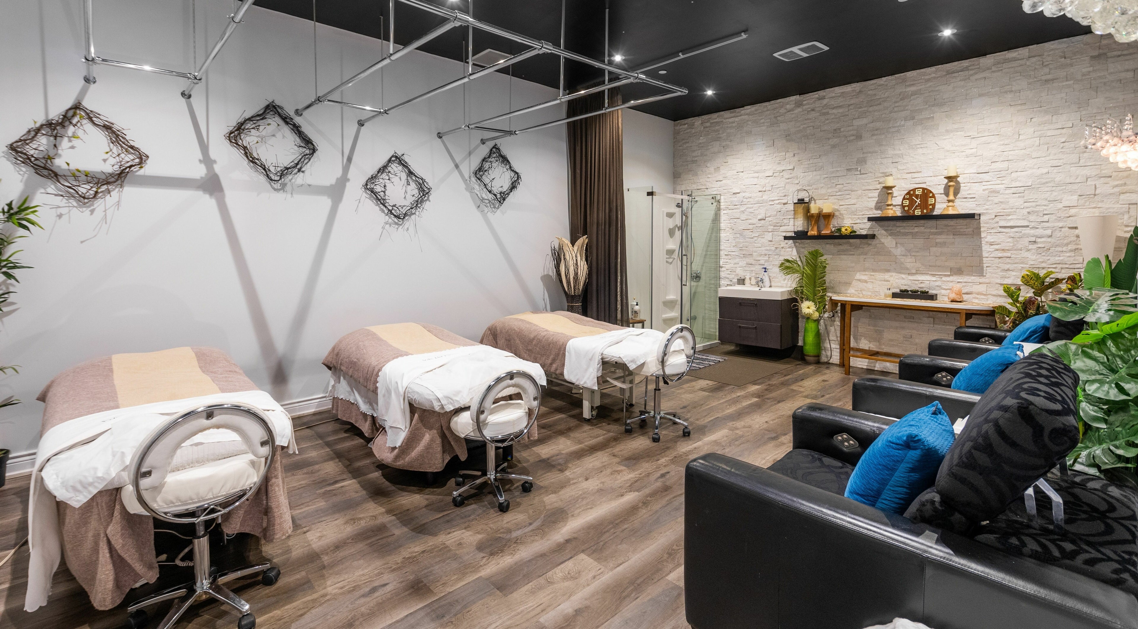 Relaxing massage room at Aroma Day Spa, Markham, Ontario, CA with three beds and cozy decor.