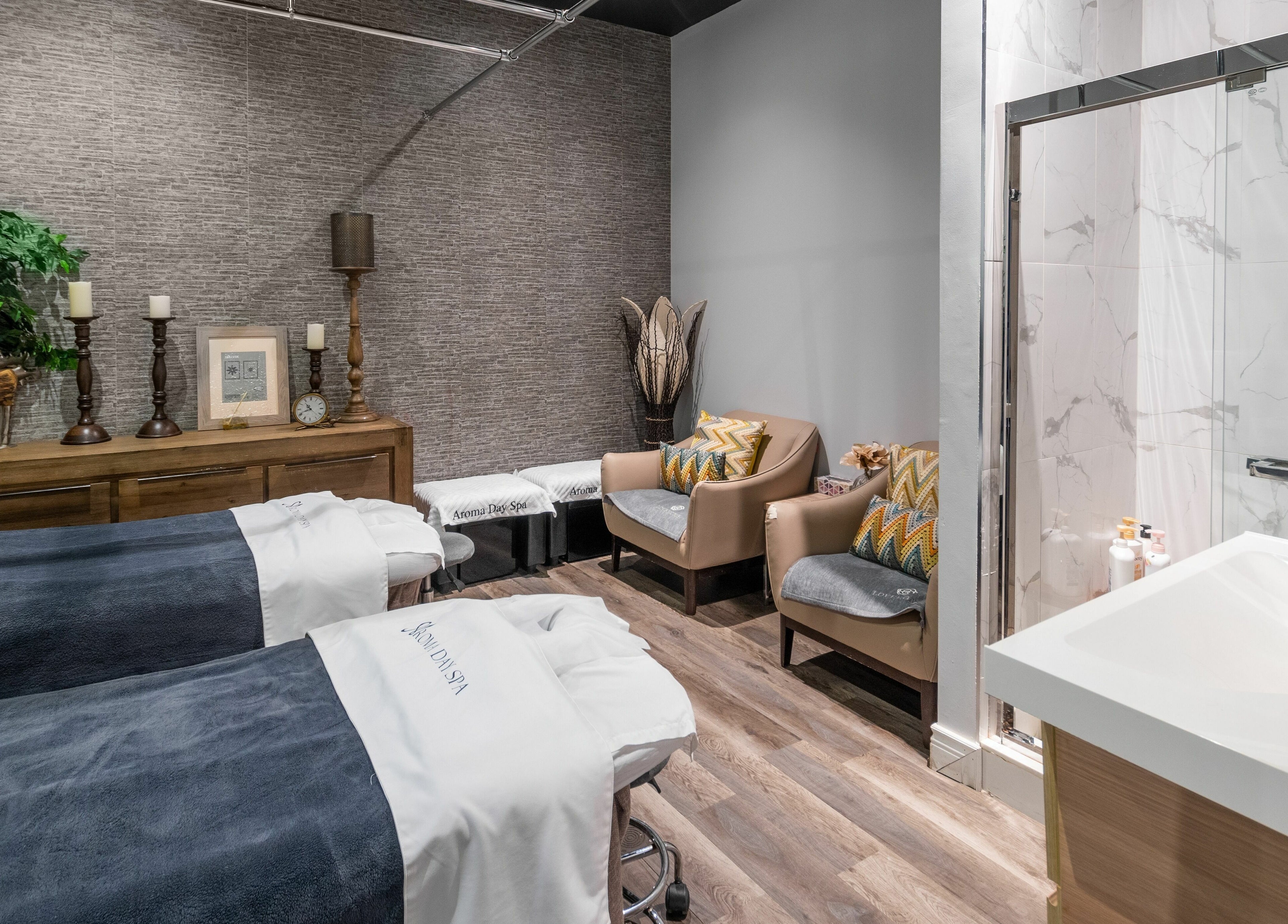Relaxing massage room at Aroma Day Spa, Markham, Ontario with plush chairs and peaceful decor.