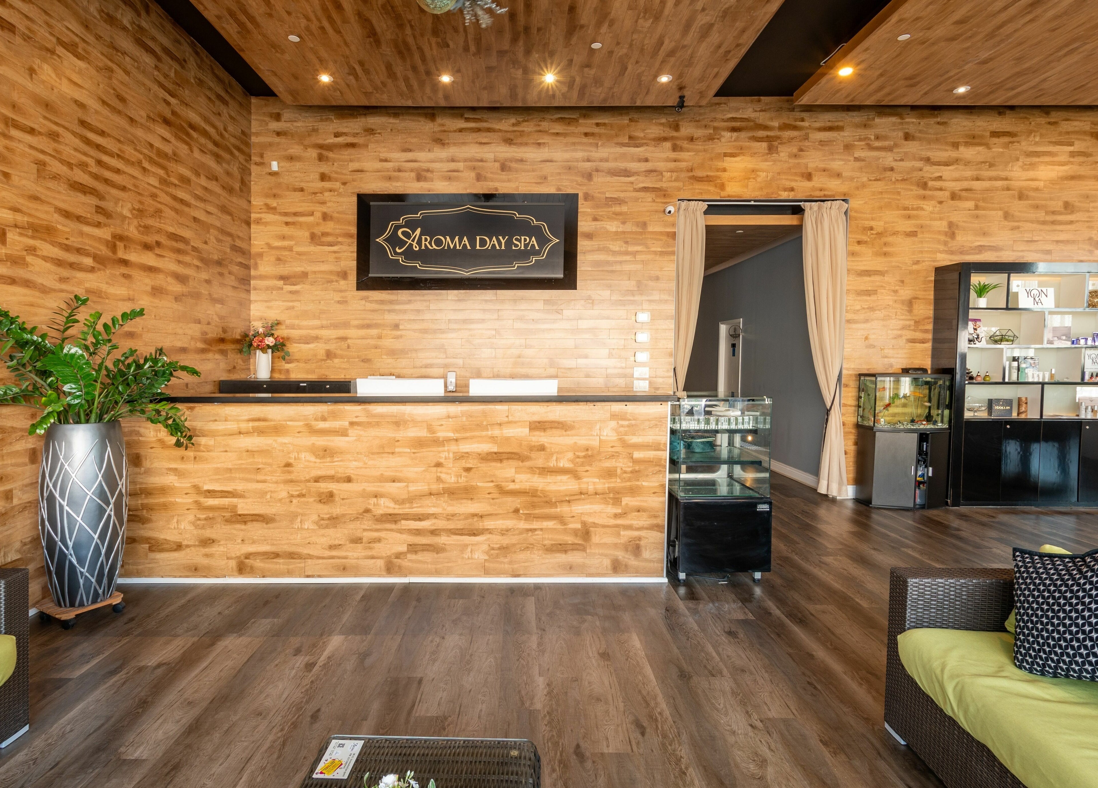 Aroma Day Spa's elegant reception area in Markham, Ontario, CA, featuring wooden decor and a cozy seating area.