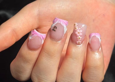 Elegant nail art with pink flowers at Nailsby.Ls, Bromley, England, GB.