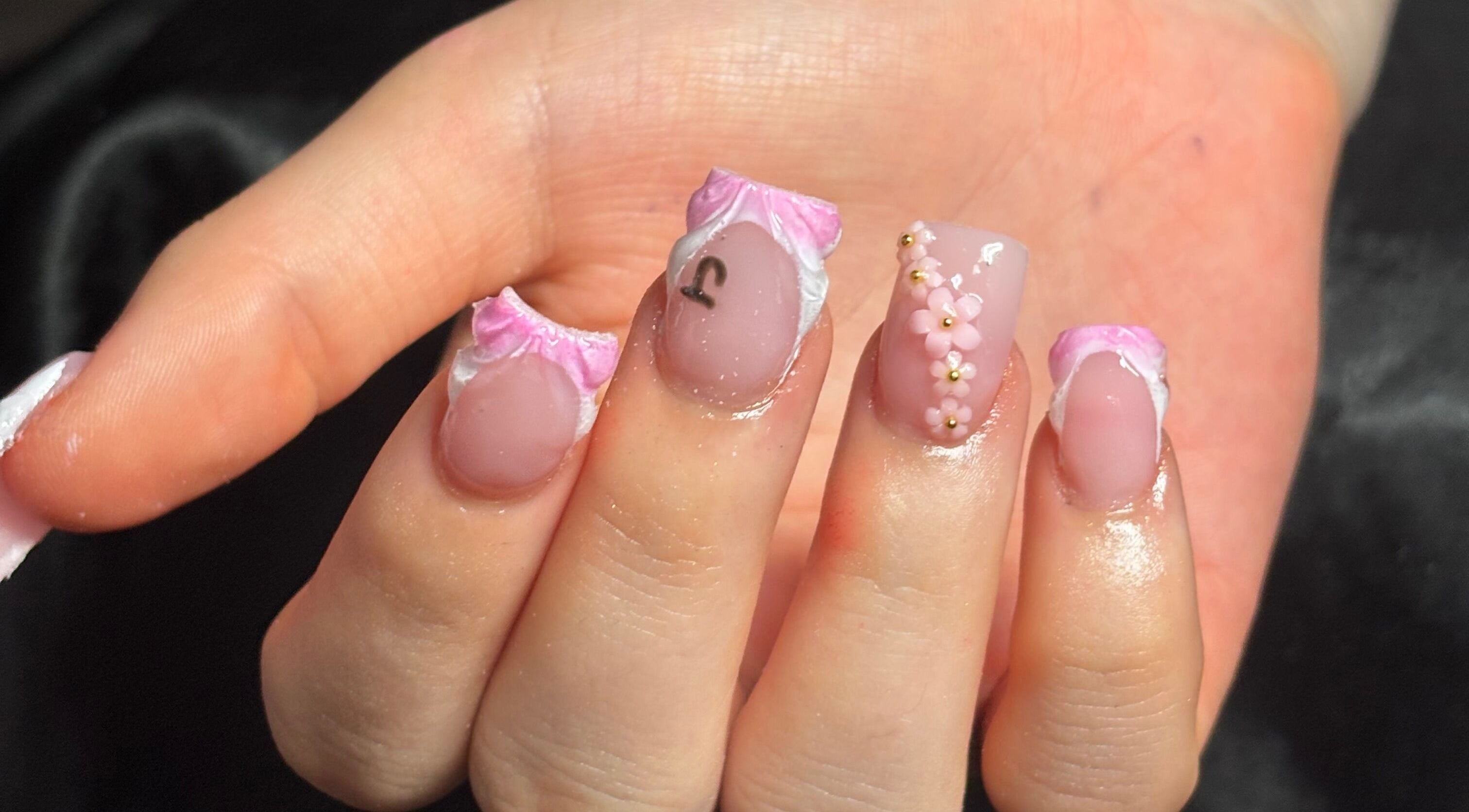 Elegant nail art with pink flowers at Nailsby.Ls, Bromley, England, GB.