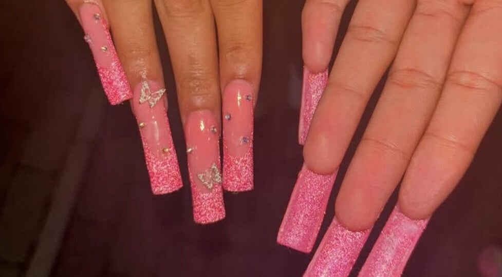 Elegant pink glitter nails with butterfly design by Nailsby.Ls in Bromley, England, GB.
