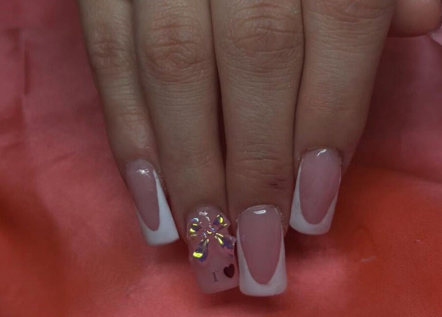 Elegant French manicure with bow detail at Nailsby.Ls, Bromley, England, GB.