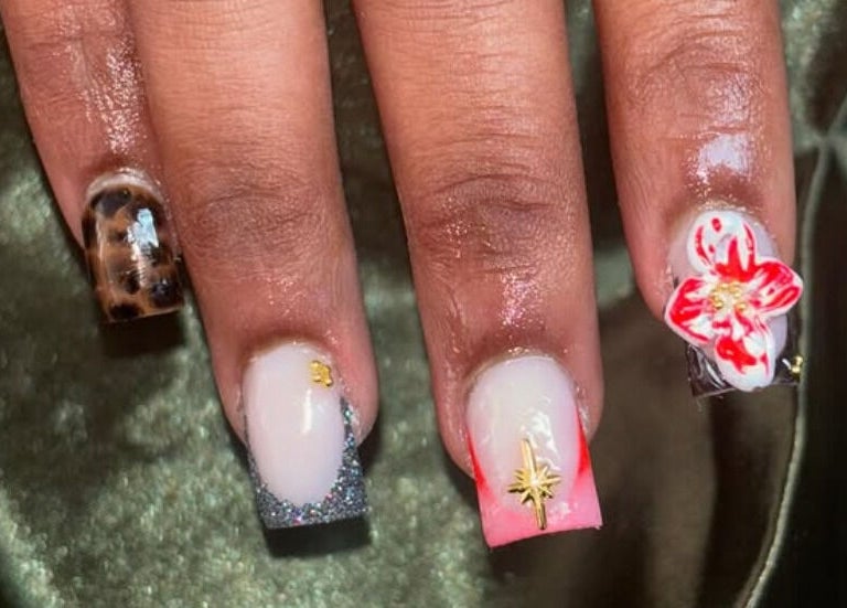 Stylish nail art at Nailsby.Ls in Bromley, England, GB, featuring vibrant floral and leopard patterns.