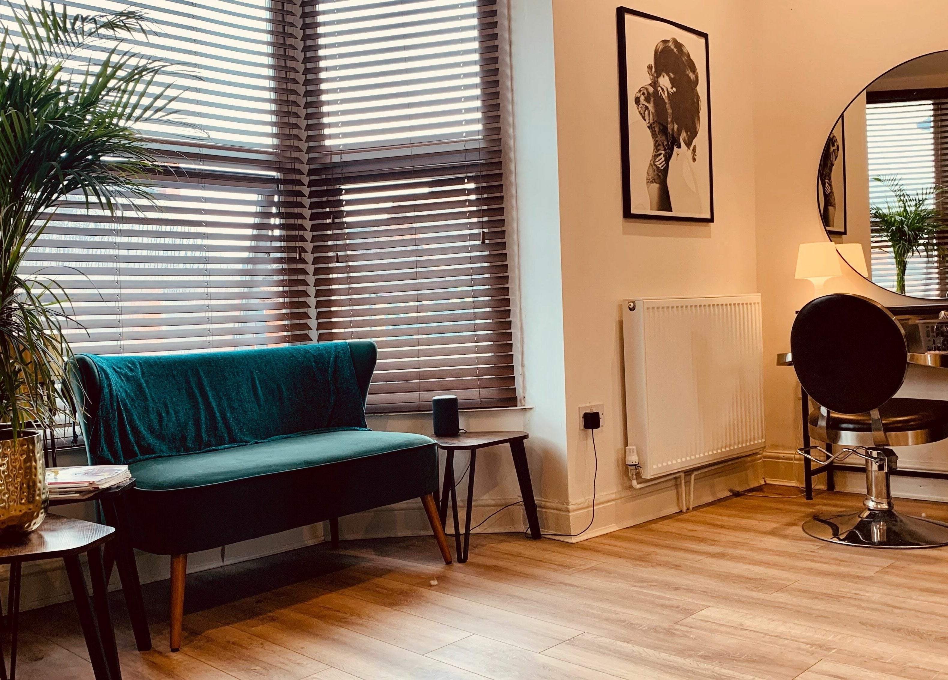 Chic salon interior at Dandy Hair in Hull, England featuring elegant seating and a styling station.