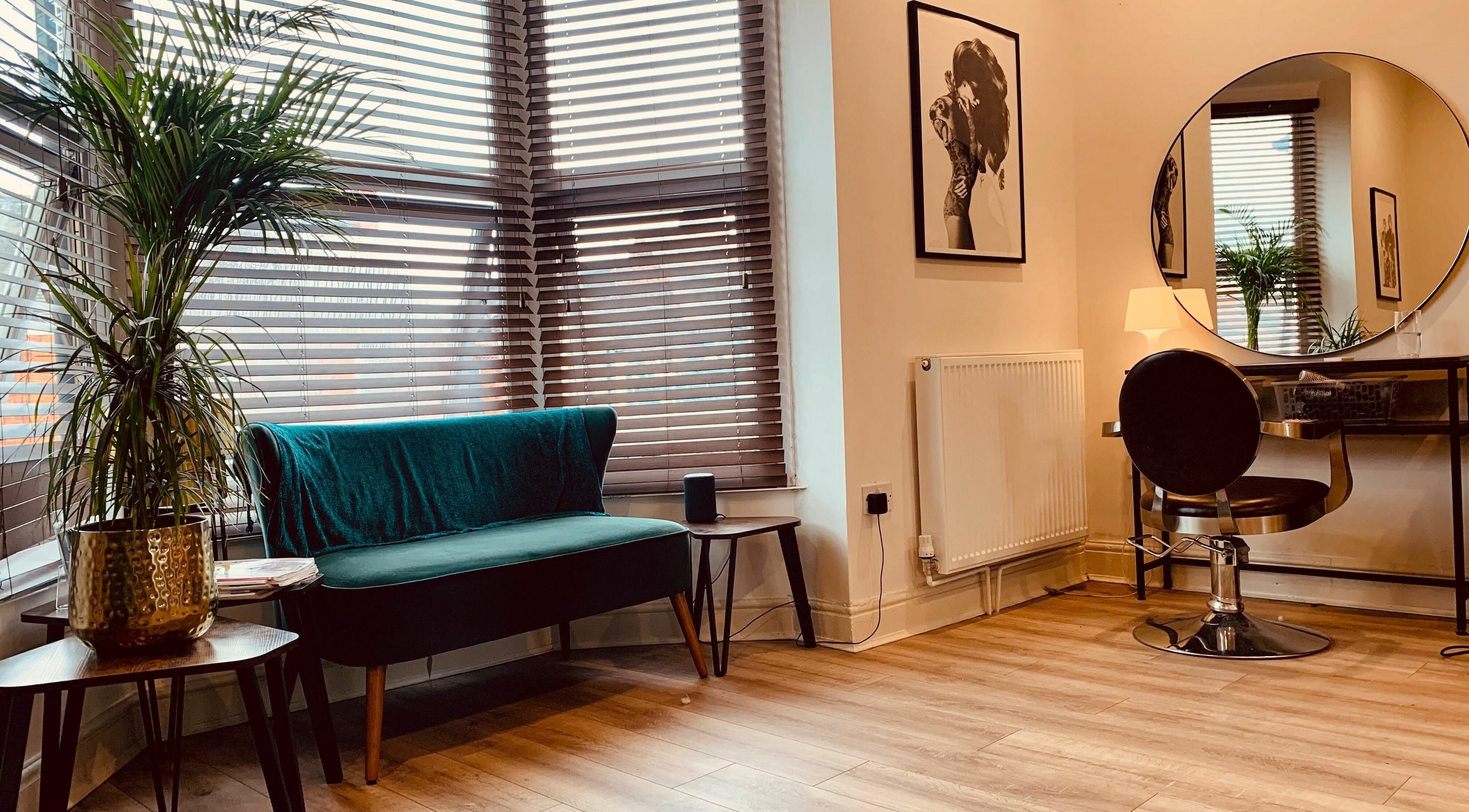 Chic salon interior at Dandy Hair in Hull, England featuring elegant seating and a styling station.