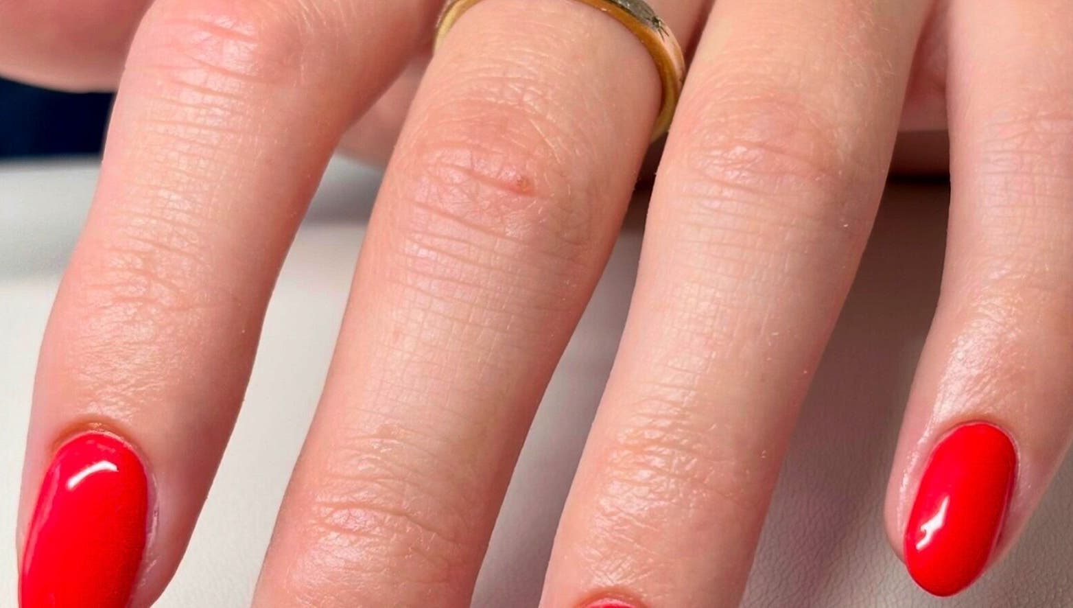 Close-up of glossy red manicured nails at Gan Catrin Rees, Cardiff, Wales, GB.