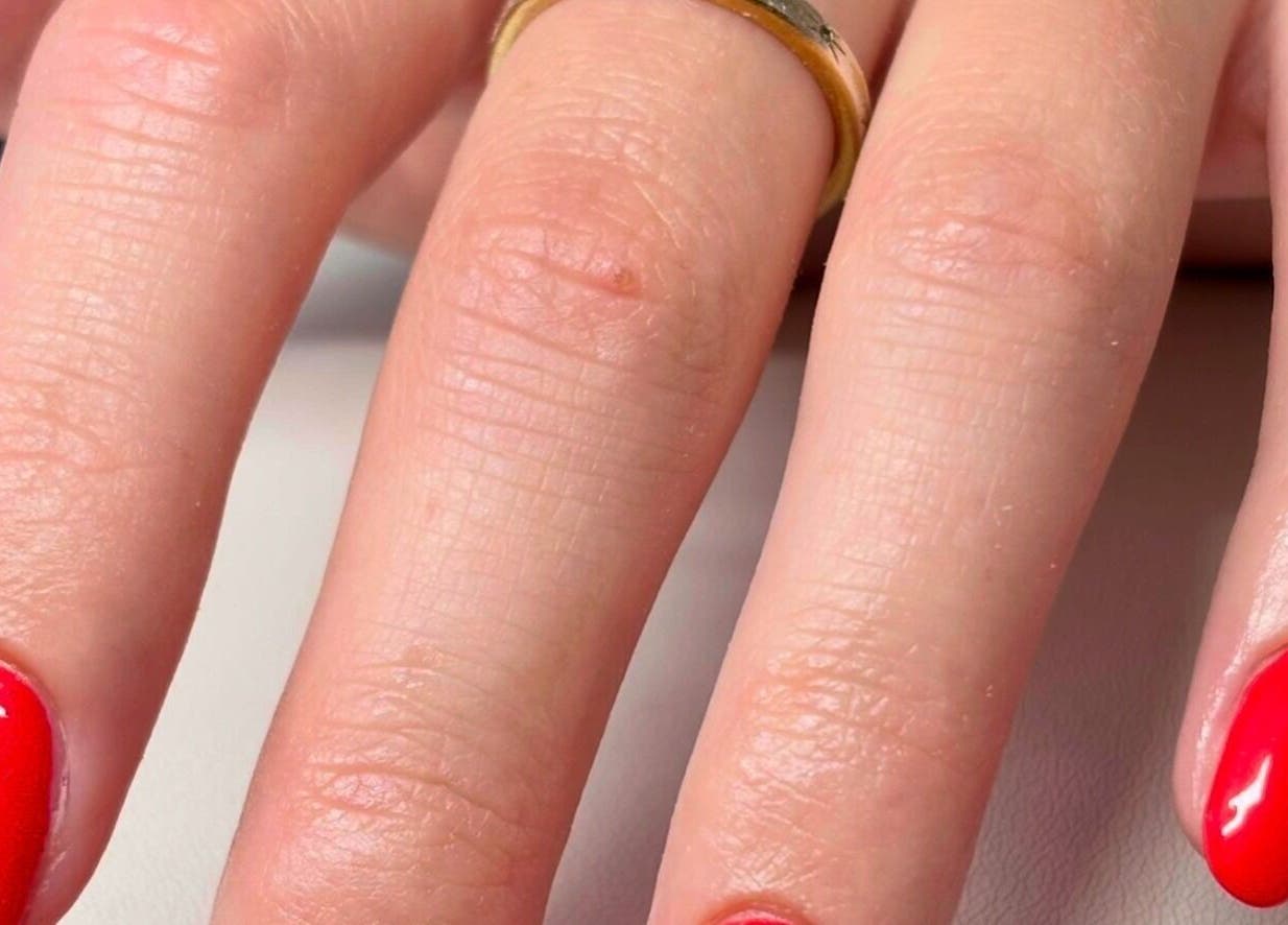 Close-up of glossy red manicured nails at Gan Catrin Rees, Cardiff, Wales, GB.