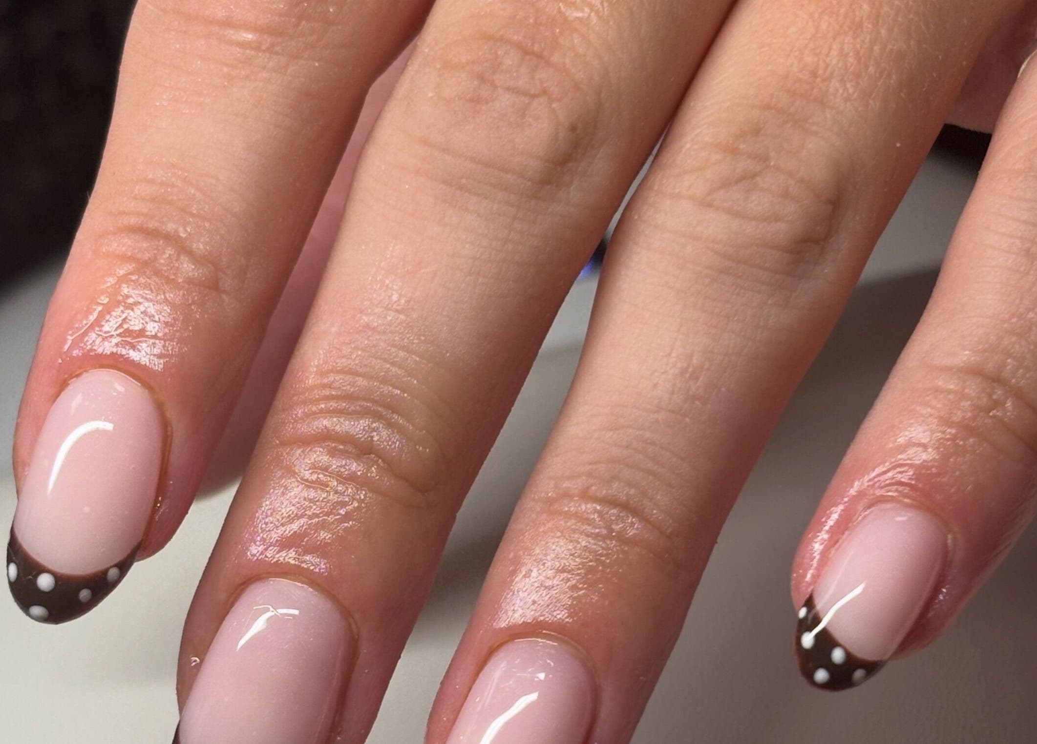 Polka dot nail art at Gan Catrin Rees in Cardiff, Wales, GB, showcasing elegant manicure skills.