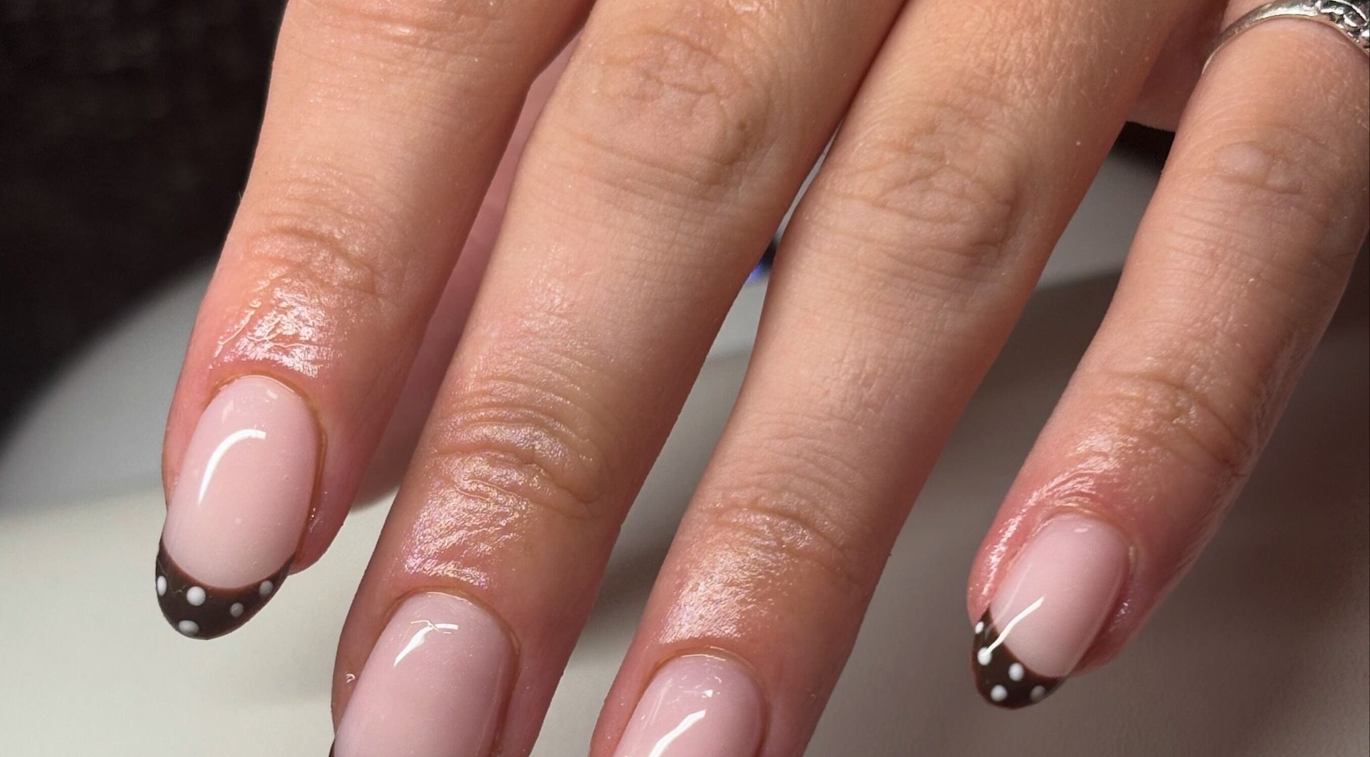 Polka dot nail art at Gan Catrin Rees in Cardiff, Wales, GB, showcasing elegant manicure skills.