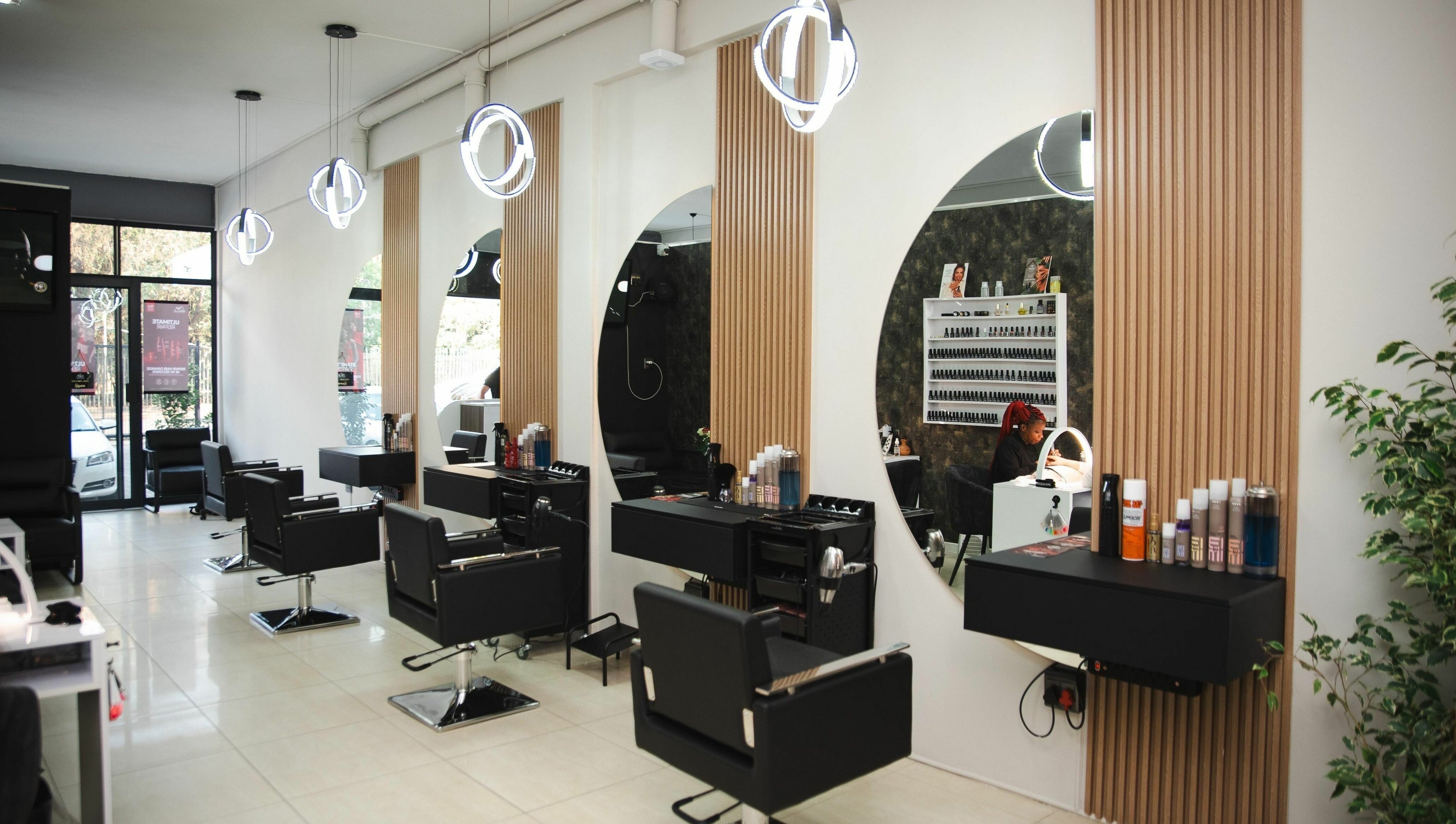 Modern salon interior at Mkh Beauty House, Johannesburg, Gauteng, ZA featuring elegant styling stations.