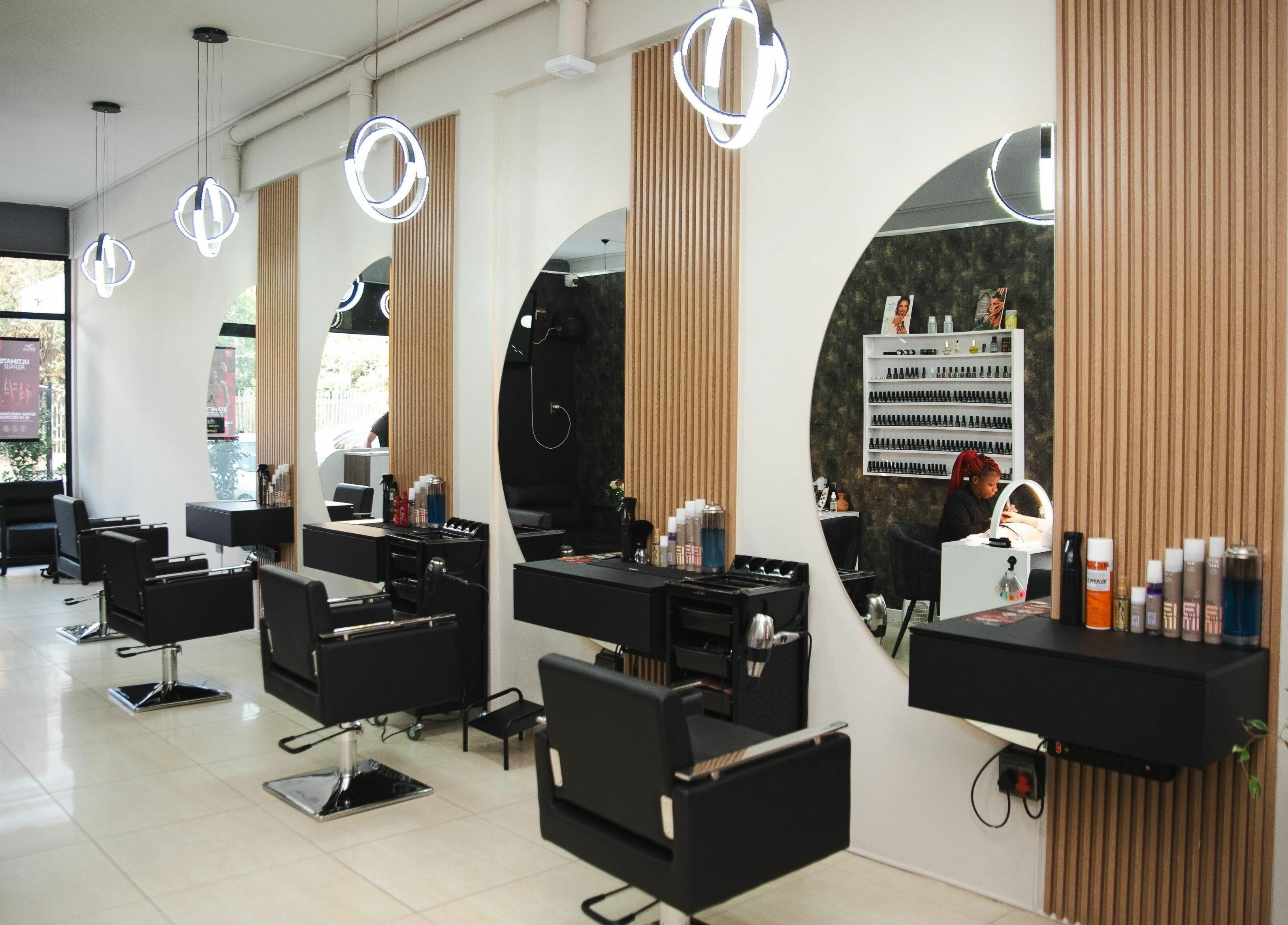 Modern salon interior at Mkh Beauty House, Johannesburg, Gauteng, ZA featuring elegant styling stations.