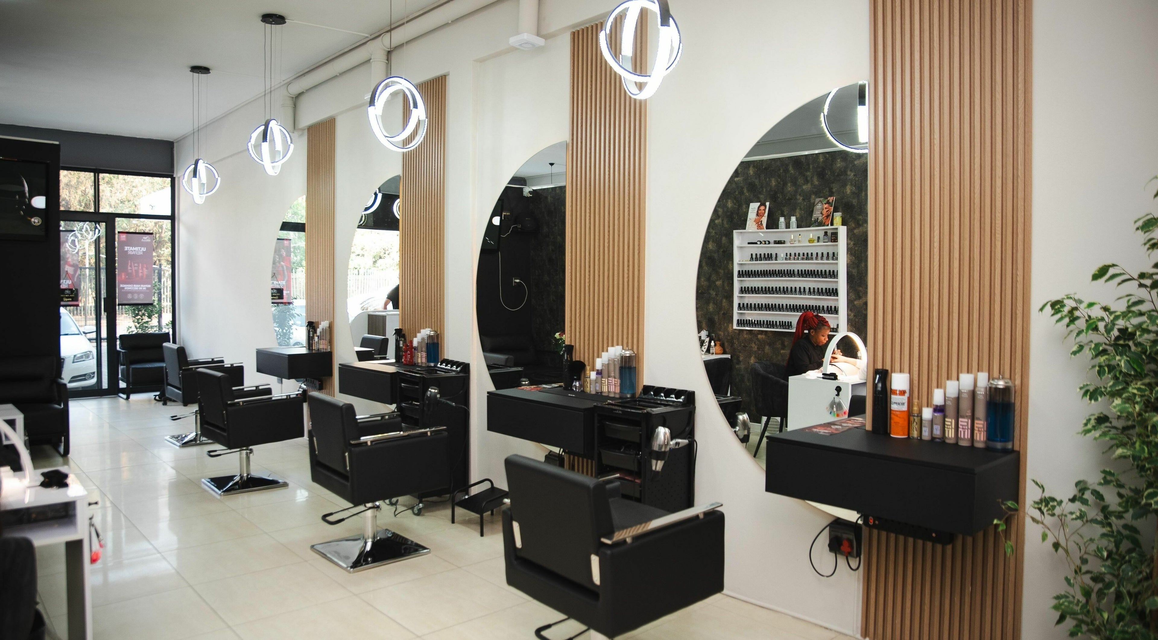 Modern salon interior at Mkh Beauty House, Johannesburg, Gauteng, ZA featuring elegant styling stations.