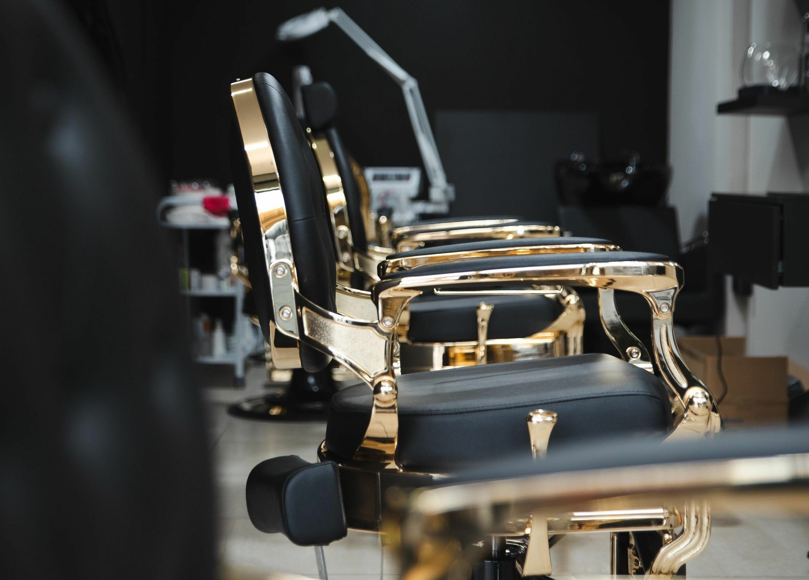 Elegant gold and black salon chairs at Mkh Beauty House in Johannesburg, Gauteng, ZA for premium grooming.