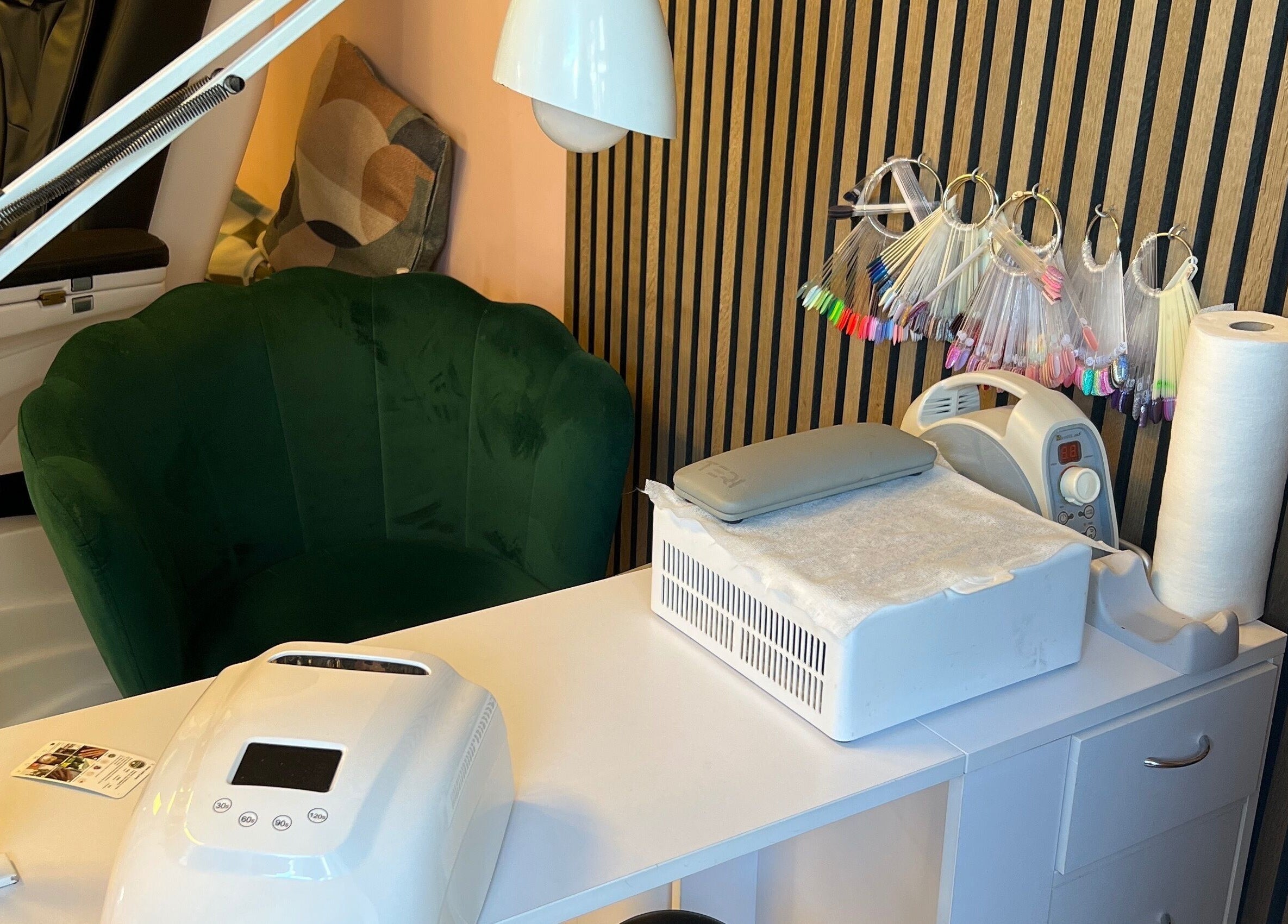 Elegant nail station setup at Beauty, Ennis, County Clare, IE with tools and a cozy green chair.