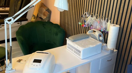 Elegant nail station setup at Beauty, Ennis, County Clare, IE with tools and a cozy green chair.