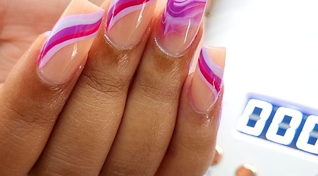 Stylish pink and purple nail design at KiKi Beauty Spot, Portmore, St. Catherine Parish, JM.